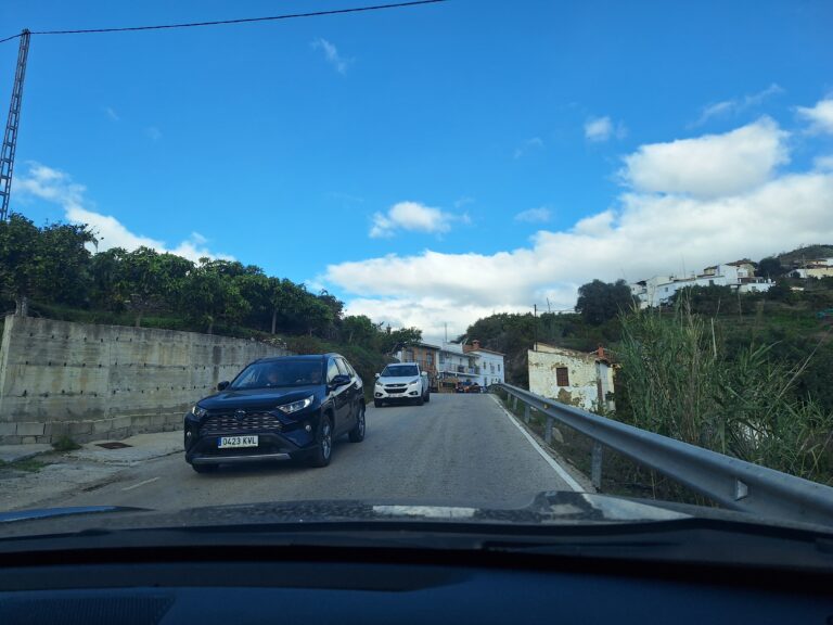 narrow road with cars approaching