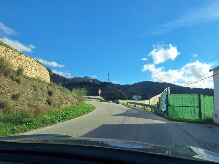 narrow winding road with blind corners leading from the main road